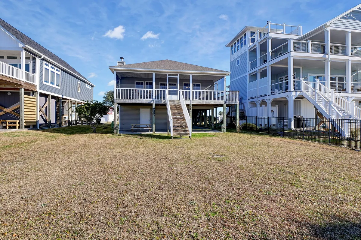 Depicts a two-story house with surrounding homes and an open yard. The scene captures the casual, communal vibe that encourages socializing, with open spaces ideal for transitioning between outdoor fun and indoor activities.